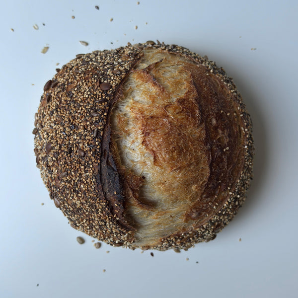 Loaf of bread with sesame seeds on a white background